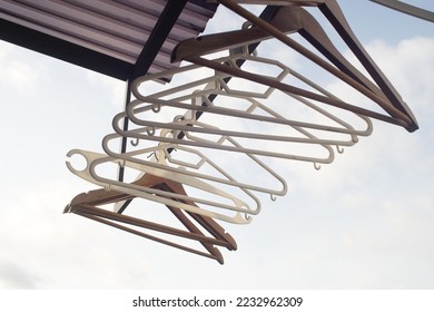 Many hangers on rods, isolated against sky background - Shutterstock ID 2232962309