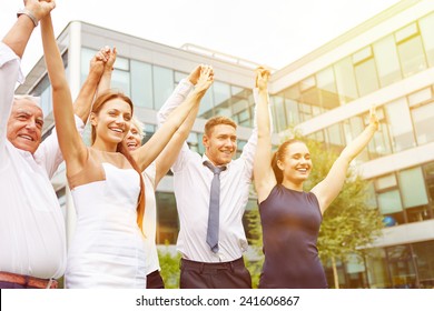 Many Happy Business People Holding Their Arms Up And Cheering