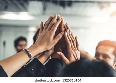 Many Happy Business People Raise Hands Together With Joy And Success. Company Employee Celebrate After Finishing Successful Work Project. Corporate Partnership And Achievement Concept.