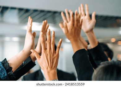 Many happy business people raise hands together with joy and success. Company employee celebrate after finishing successful work project. Corporate partnership and achievement concept. uds - Powered by Shutterstock