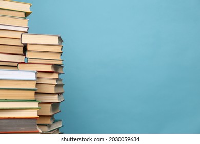Many hardcover books on turquoise background, space for text. Library material - Shutterstock ID 2030059634