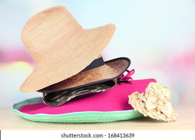 Many hats on table on light background