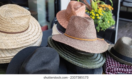 Many hats from the sun in different colors. Beach hats for summer, Design of women's and man's beach hats. Summer travel and vacation concept. Top view of Straw hats. Fasionable concept - Powered by Shutterstock