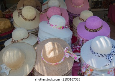 Many hats from the sun. Women's designer hats from the sun of different colors. Beach hats for summer, Design of women's beach hats.