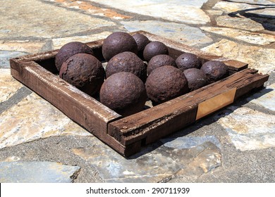 Many of historical old cannon balls, heap of iron rusty balls.
