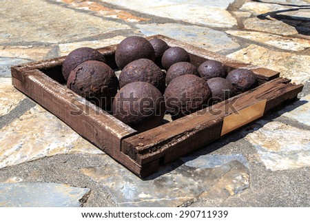 Many of historical old cannon balls, heap of iron rusty balls.