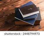 Many Holy Bible books on a wooden table. Christian religion