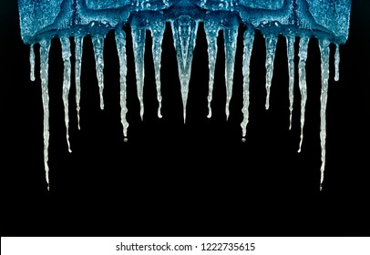 many icicles on black background isolate close-up