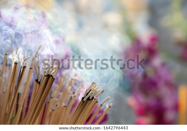 Many incense sticks were lit to\
perform Buddhist rituals, Smoke from a large amount of incense,\
Asian beliefs about Buddhist rituals, Religious\
ceremony