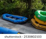  Many inflatable boats for rafting. The boats are lying on top of each other. Equipment for rafting.