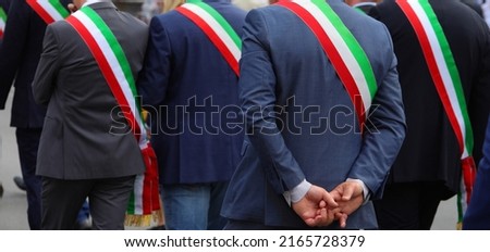 Many italian mayors with tricolor green white and red band during meeting
