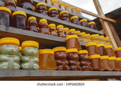 Many jars with fresh organic honey on farm market. Colorful honey on a market in Altai.