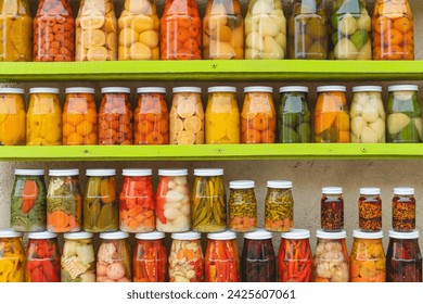 Many Jars with fruity compotes jams and pickled vegetables. Preserved fruits - Powered by Shutterstock