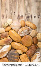 Many Kinds And Kinds Of Bread Collected In One Place On A Wooden Old Shop Counter As A Decoration For A Traditional Bakery. View From Above.