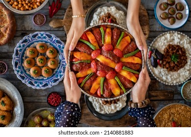 Many kinds of food at the hands of family members. Local food named izmir kofte . İftar concept. Variation of local homemade foods.    - Shutterstock ID 2140881883
