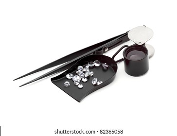 Many kinds of jewelers tools - Shovel Bead scoop with loop Handle, magnifier, tweezers and  Diamond with facets that sparkle brightly in the light.