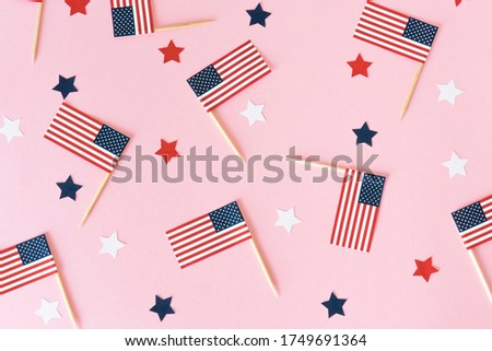 Many little american flags and stars on pink background, flat lay. 4th of july, happy usa independence day. Celebration in America, good mood.