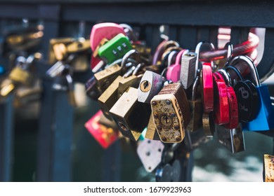 Many Locks Affixed To A Railing