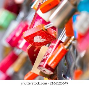 Many Locks Caught On A Fence