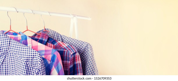 Many Long Sleeve Colorful Checkered Shirts On Hangers In The Showroom. Shopping And Fashion With A Selection In A Wide Range Concept.