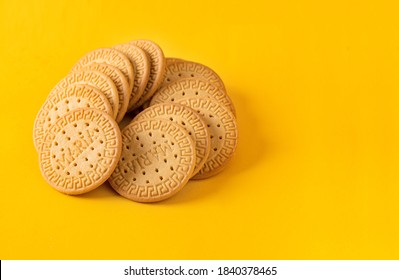 Many Marie biscuits  on bright yellow background. Modern cookies concept. 