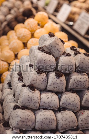 
Many marzipan candies of various shapes lie on the storefront. Marzipan is a dessert symbol of Hungary. Selling sweets at the Budapest Christmas Market.