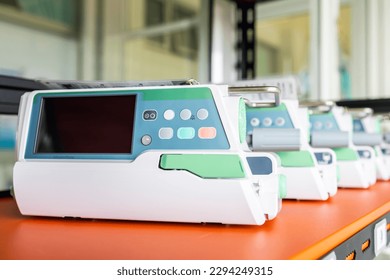 Many of medical infusion pump in medical equipment or device unit that prepare and calibrate for patient in hospital. White tool with screen monitor with blur background.Instrument use in ICU. - Powered by Shutterstock