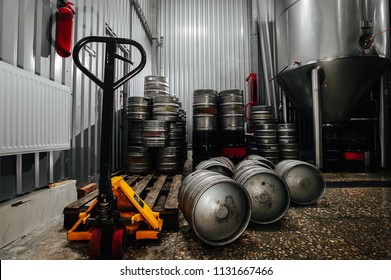 Many Metal Beer Keg Stand In A Warehouse Of Brewery. Time To Delivery. Beer Kegs On The Production Line In The Factory