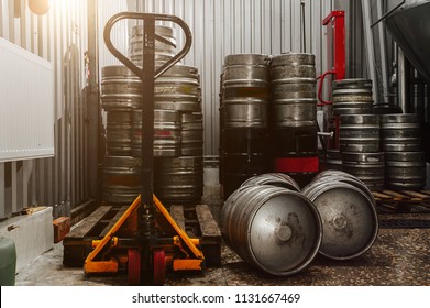 Many Metal Beer Keg Stand In A Warehouse Of Brewery. Time To Delivery. Beer Kegs On The Production Line In The Factory