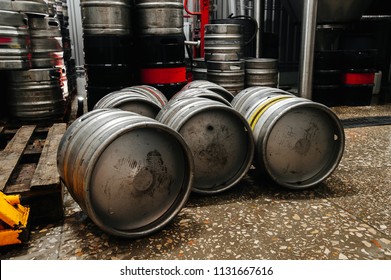 Many Metal Beer Keg Stand In A Warehouse Of Brewery. Time To Delivery. Beer Kegs On The Production Line In The Factory 