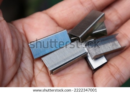 Many of Metal staples for stapler on white background. Selective focuss blurry background 