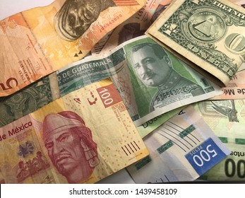 Many Mexican Pesos And Other Latin American Money Bills Spread Over A Wooden Desk Inside A Small Business Office