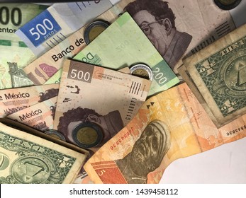 Many Mexican Pesos And Other Latin American Money Bills Spread Over A Wooden Desk Inside A Small Business Office