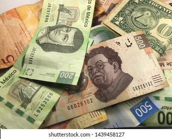 Many Mexican Pesos And Other Latin American Money Bills Spread Over A Wooden Desk Inside A Small Business Office