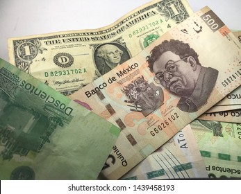 Many Mexican Pesos And Other Latin American Money Bills Spread Over A Wooden Desk Inside A Small Business Office