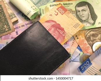 Many Mexican Pesos And Other Latin American Money Bills Spread Over A Wooden Desk Inside A Small Business Office