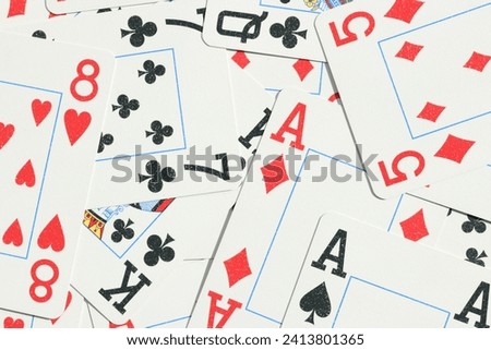 Many miscellaneous jumbled playing cards surface. Mixed playing cards background. Assorted play cards backdrop.
