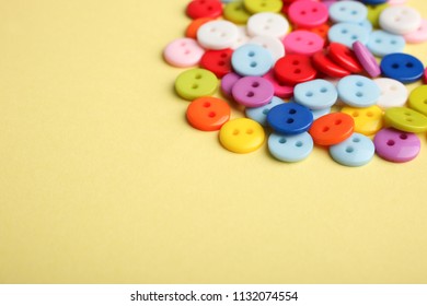 Many multicolored buttons on a yellow background. - Shutterstock ID 1132074554