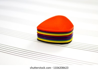 Many multi-colored mediators lie in a stack on top of each other in a random order on a note-book for notes. Close-up. Background blur.