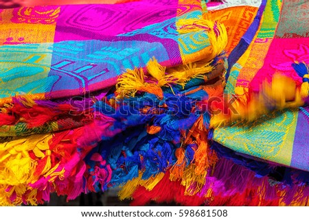 Many multicolored textiles being representative for the latin america culture and sold as souvenirs at chichen itza, yucatan mexico.