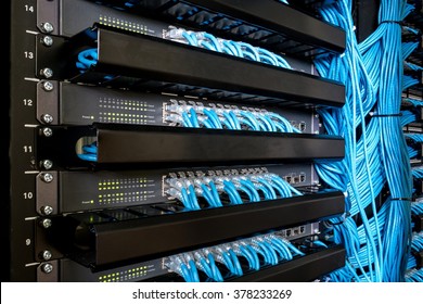 Many network switch hubs and ethernet cable in rack cabinet. Network connection technology and has a status LED to show working status