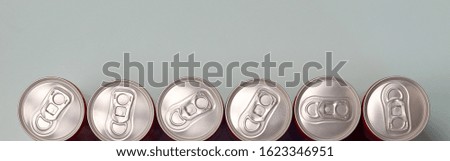 Many new aluminium cans of soda soft drink or energy drink containers. Drinks manufacturing concept and mass production