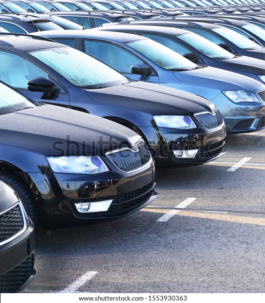 many new cars\
on a parking lot at a car\
dealer