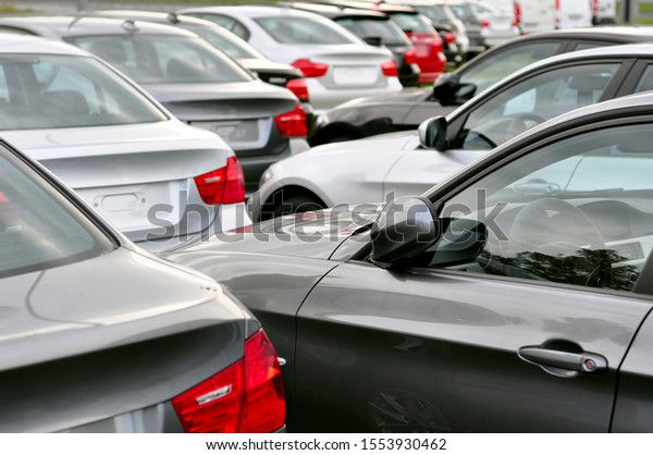 many new cars\
on a parking lot at a car\
dealer