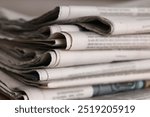 Many newspapers in different languages as background, closeup