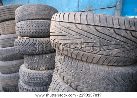 Many old damaged wheels lie in a pile