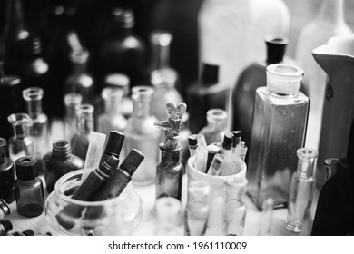Many Old Deutsch Vintage Medical Glass Capacity. Detail Of Retro Chemical Pharmaceutical Science Researches. Small Bottles Different Sizes From Times Of World War II. WW2 WWII. Black And White.