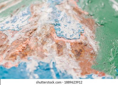 Many Old Paint Layers On The Wall With Cracks And Holes