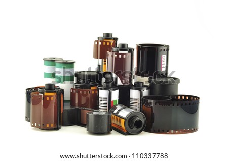 many old photo film rolls over white background
