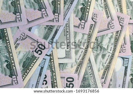 Many one hundred and fifty dollar bills on flat background surface close up. Flat lay top view